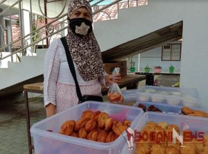 Hasna Paulu saat mengangkan kuenya