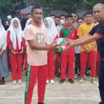 KONI Bolmut Serahkan Bantuan di HUT SMK Kaidipang